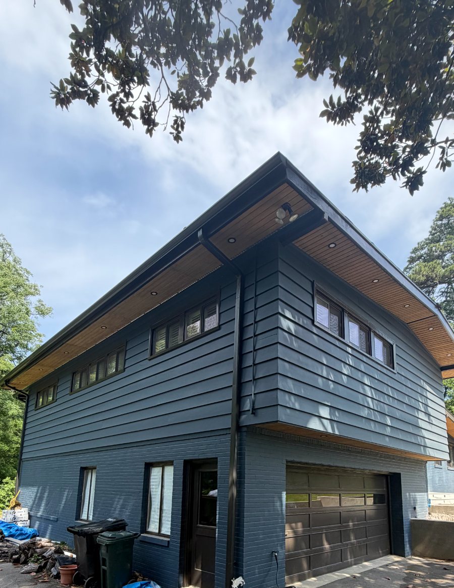 Two story exterior repainted navy with stained soffits